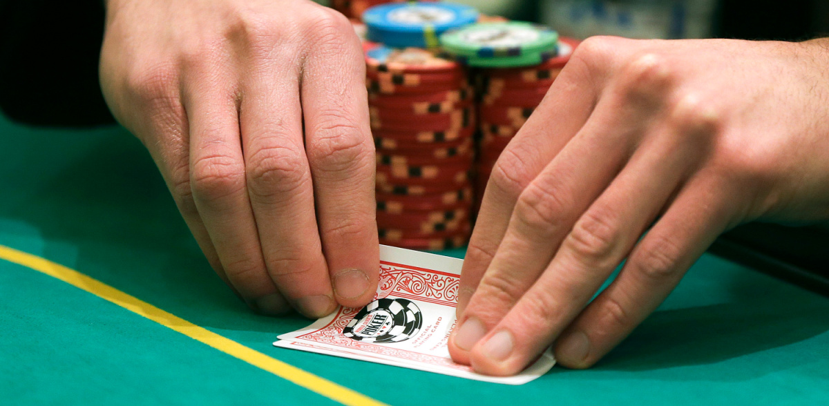 A person playing Texas Hold 'Em at a card room on a story about the city of Dallas attempting to legalize them.