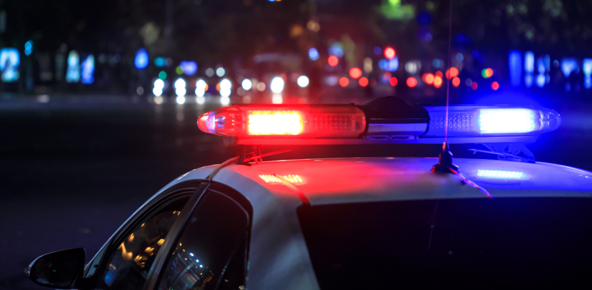 A police car with lights on at night on a story about a round up of illegal gambling busts in Texas.
