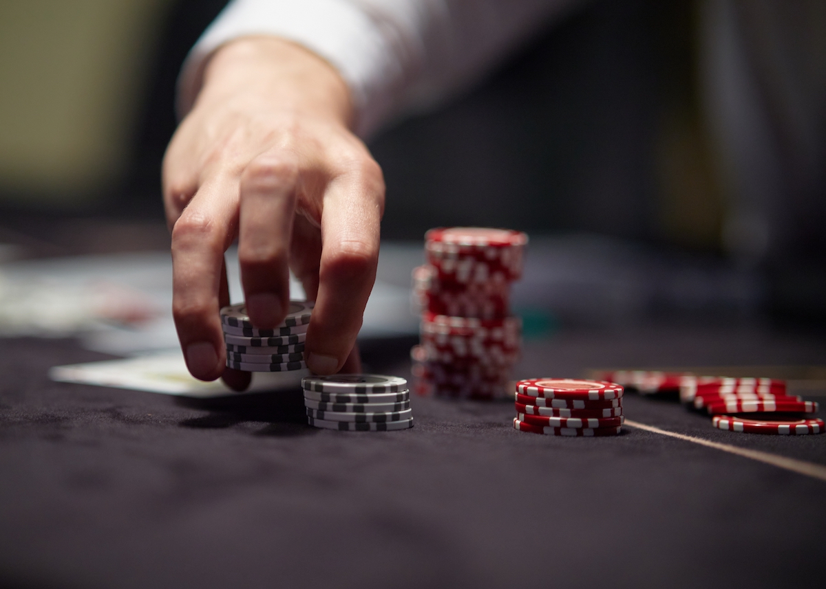 Dealer moving chips on poker table for story on zoning decision questioning legality of cardrooms in Dallas