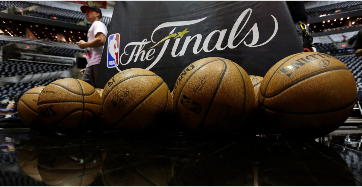 NBA Finals banner over a rack of basketballs. ESPN analysts may have swayed betting action on ESPN Bet