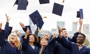Graduating students throw their caps in the air. Texas public education and veterans' services received a little more than $2 billion from the lottery's second-best revenue year ever.