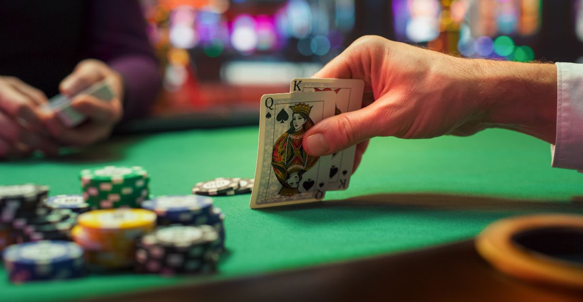 anonymous person showing cards in poker game