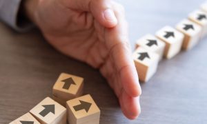 arrow blocks being prevented from moving forward by a hand
