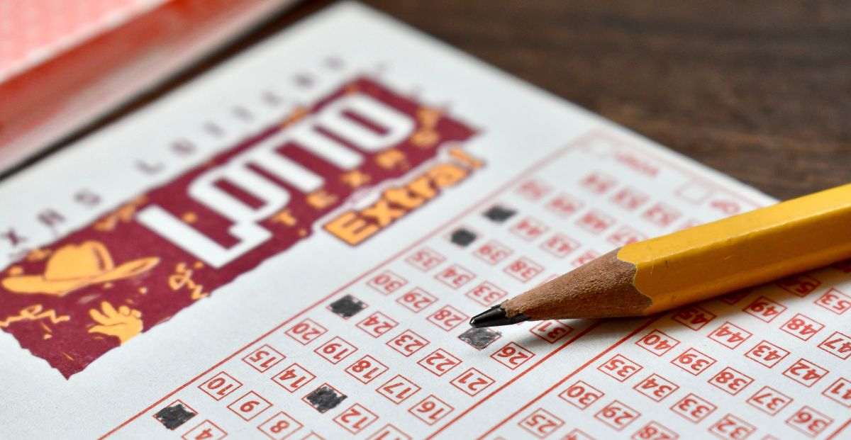a lotto texas ticket being filled out with a pencil