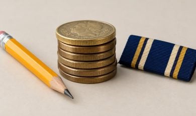 A stack of gold coins sits beside a yellow pencil and a military-style ribbon on a neutral background.